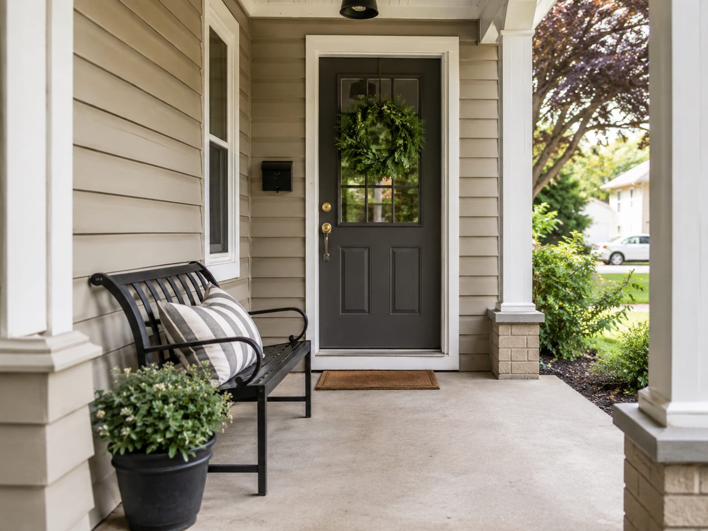 Front porch furniture arranged with clear space around the doorway and walking path