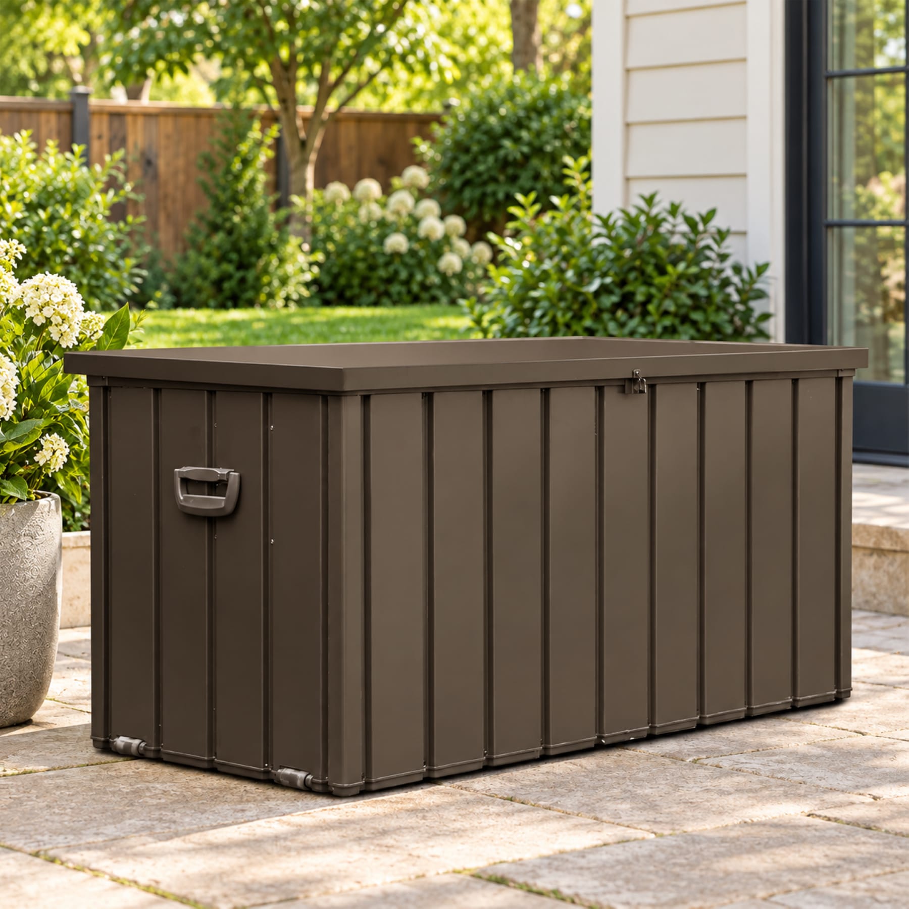 Dark brown 100-gallon outdoor steel deck box with a lockable lid on a residential backyard patio