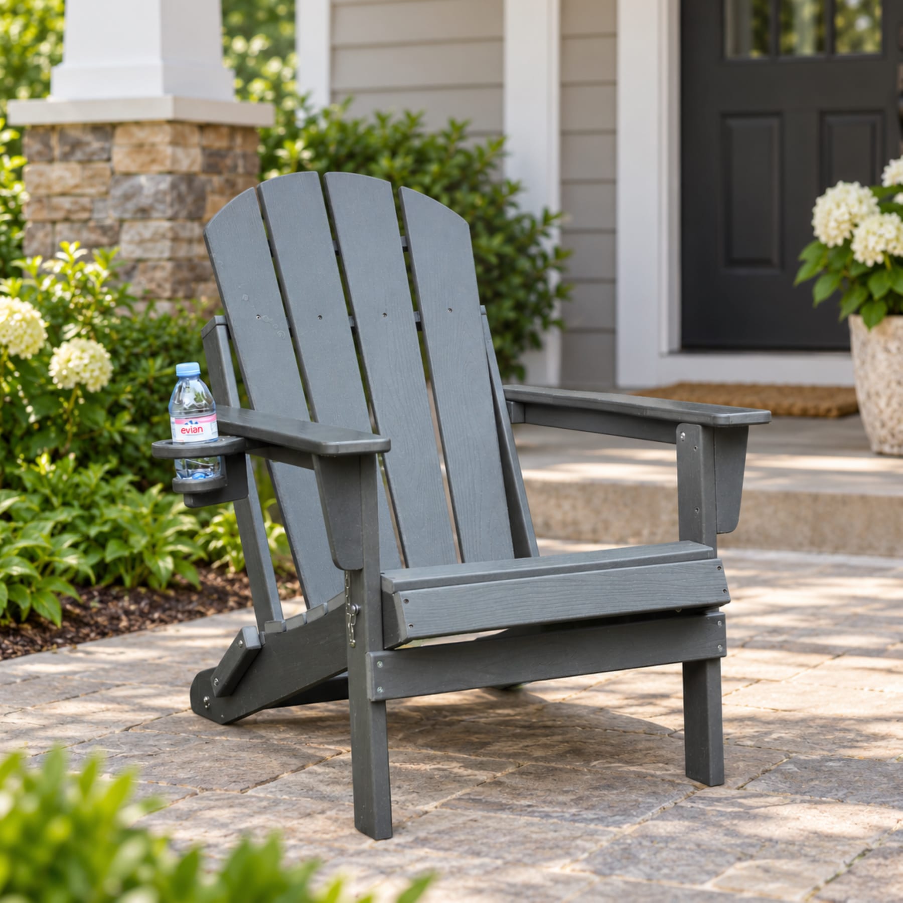 Gray folding HDPE Adirondack chair with cup holder on an American front porch