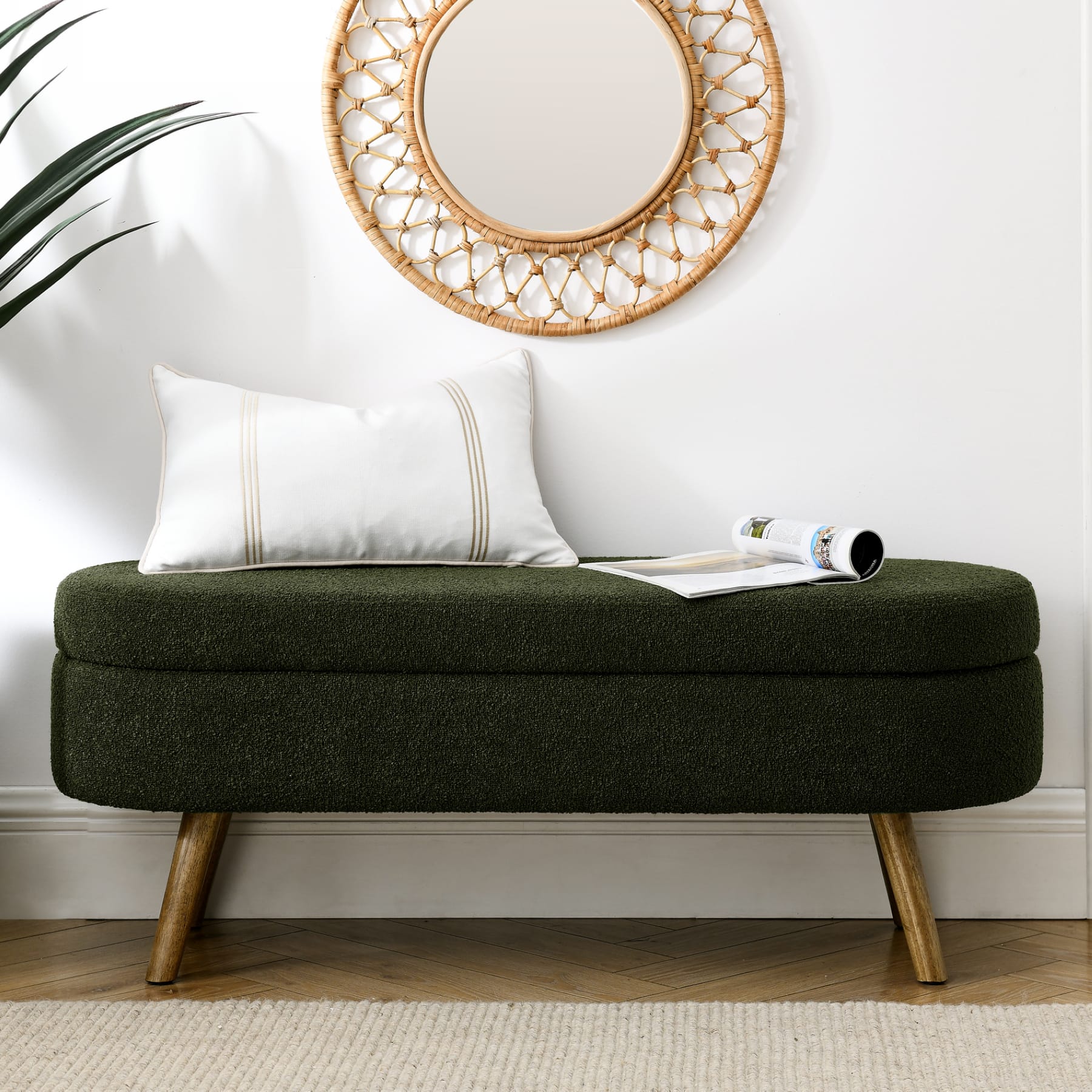 Green upholstered storage bench placed along a wall in an entryway