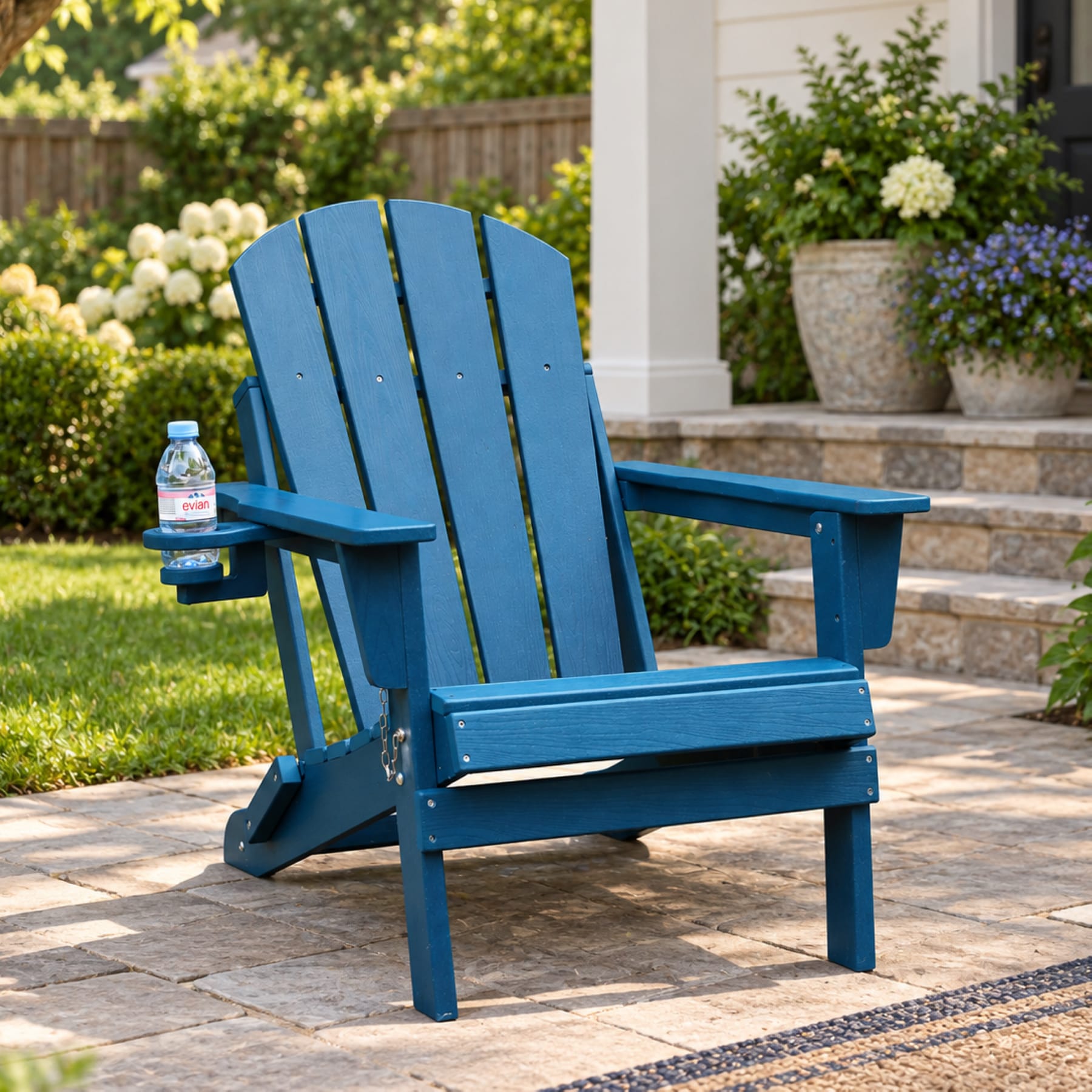 Navy Blue folding HDPE Adirondack chair with cup holder on a bright American front porch
