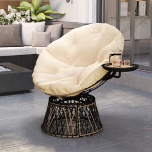 Outdoor swivel papasan chair with beige cushion and built-in side tray on a patio