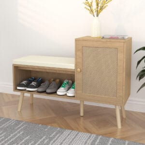 Shoe storage bench with cabinet, cushioned seat and faux rattan door in an entryway