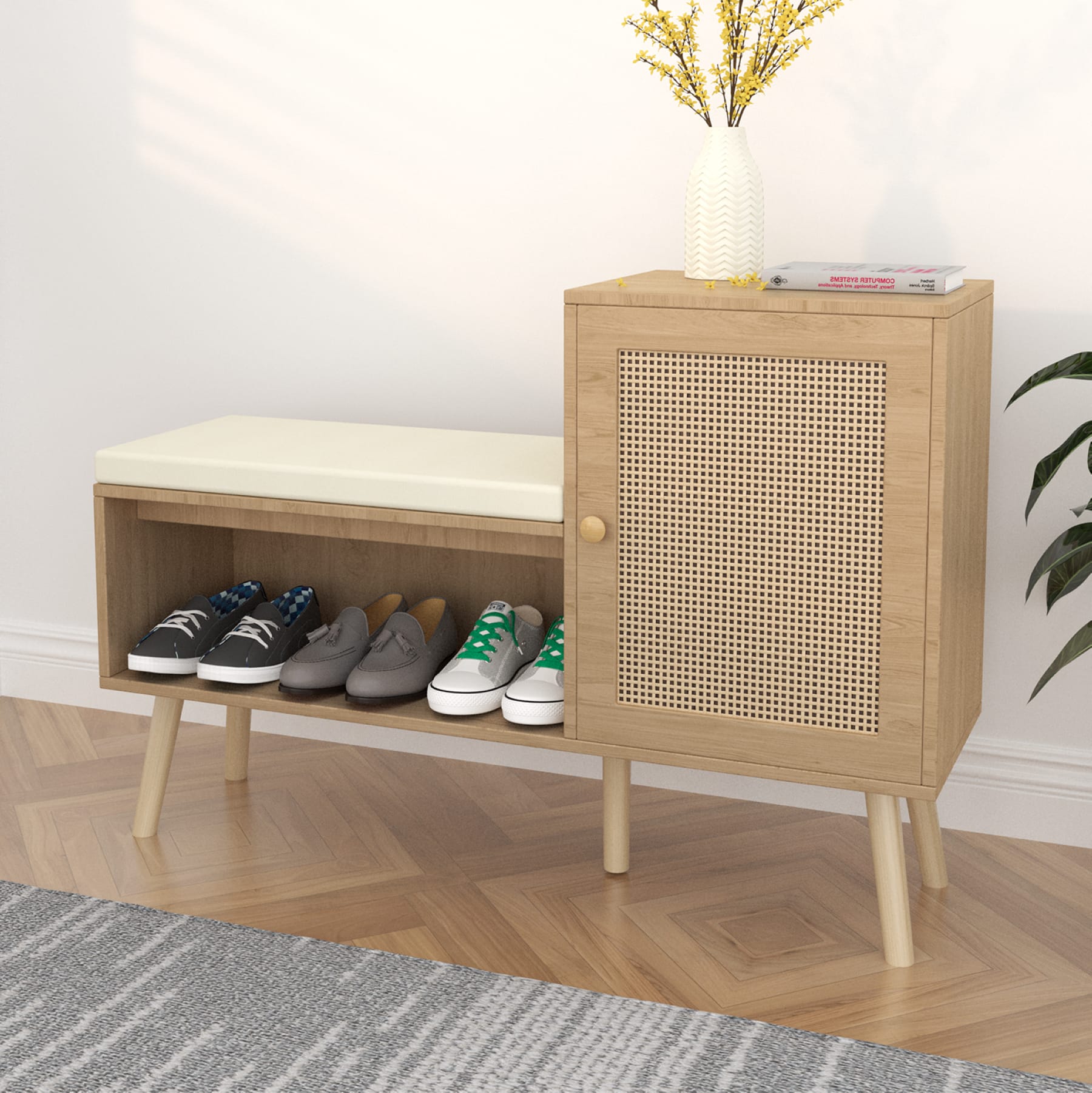 Shoe storage bench with cabinet, cushioned seat and faux rattan door in an entryway