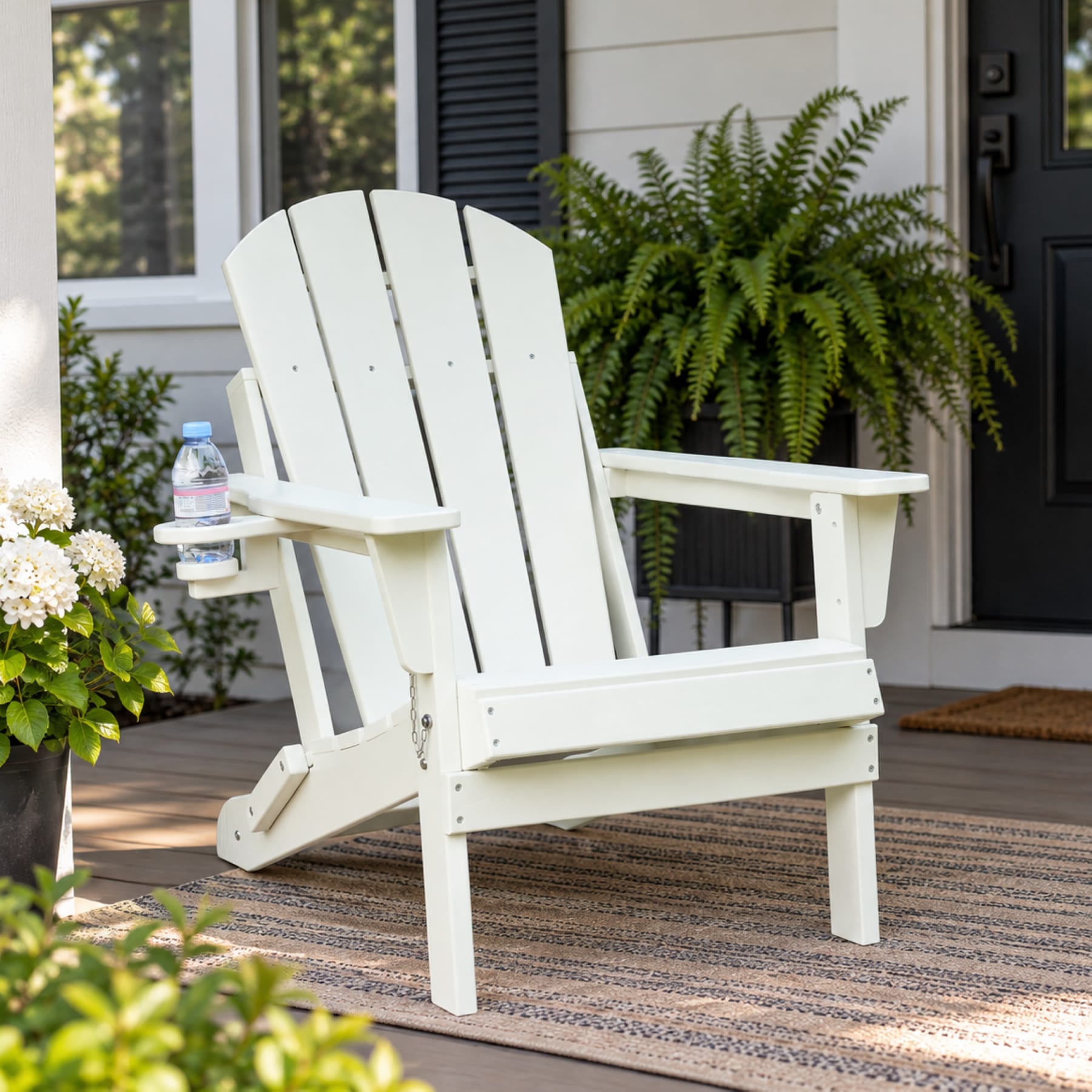 White folding HDPE Adirondack chair with cup holder on a bright American front porch