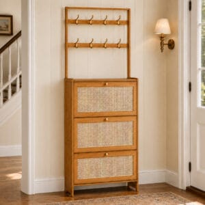 Brown bamboo shoe cabinet with three rattan-style flip drawers and eight coat hooks in a narrow entryway