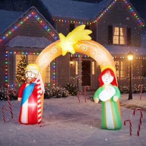 7.6 ft lighted Christmas inflatable nativity arch with Joseph, Mary holding baby Jesus, and a glowing Bethlehem star in a snowy front yard
