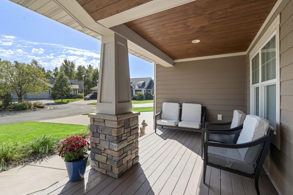 Covered porch showing sheltered seating, wind-driven rain exposure, and the roof drip line