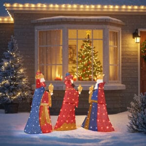Three lighted Wise Men Christmas decorations carrying gifts, displayed in a snowy front yard with warm white LED lights